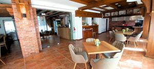 a dining room with tables and chairs and a brick wall at Aparthotel & Restaurant Razlog Spa Included in Razlog