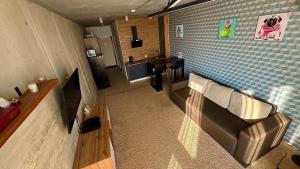 a living room with a couch and a kitchen at Smart apartment -Має Резервне живлення in Yuzhne
