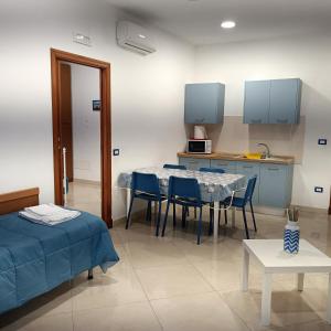 a room with a table and chairs and a kitchen at Nonnacettyhouse in Torre del Greco