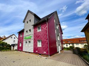 a building painted in different colors on a street at Heilotel in Heilbad Heiligenstadt +33 photos