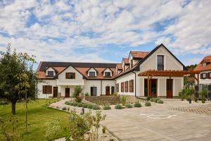 a large house with a courtyard in front of it at Villa Olea in Tihany