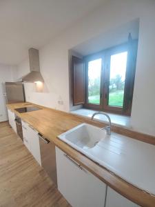a kitchen with a sink and a window at Lar da avoa in Ouviaña