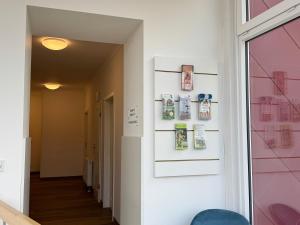 a hallway with a wall with pictures on it at Heilotel in Heilbad Heiligenstadt