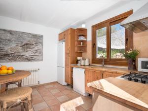 a kitchen with wooden cabinets and a counter top at Flor de Besso in Llucmajor
