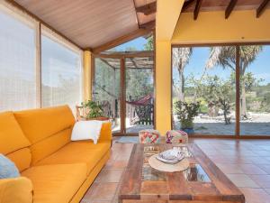 a living room with a couch and a table at Flor de Besso in Llucmajor