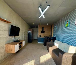 a living room with a couch and a flat screen tv at Smart apartment -Має Резервне живлення in Yuzhne +15 photos