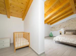 a bedroom with a bed and a wooden ceiling at Villa Prestige Azinetti with Pool in Štokovci +26 photos