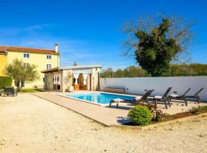 a villa with a swimming pool and a house at Villa Prestige Azinetti with Pool in Štokovci