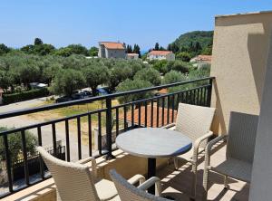 a patio with a table and chairs on a balcony at Villa Ponta in Kaluđerac +6 photos