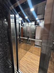 a glass elevator in a building with a wooden floor at Hotel HB Grand in Anūpgarh