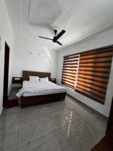 a bedroom with a bed and a large window at Hotel HB Grand in Anūpgarh