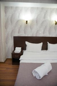 a bedroom with two beds with white pillows at Sultan Beibarys in Astana