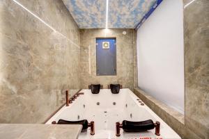 a bath tub in a bathroom with a window at Hotel Armani Suites-Free Airport Drop in New Delhi