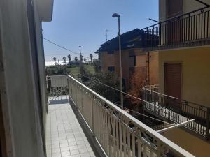 a balcony of a building with a view of the ocean at Appartamento Serenity in Marina di Ascea
