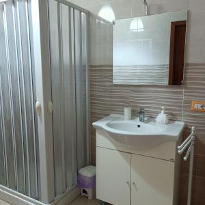a bathroom with a white sink and a shower at Nonnacettyhouse in Torre del Greco