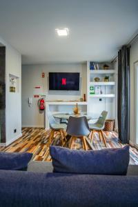 a living room with a table and chairs at Oceanway Apartment in the Center of Baleal in Ferrel