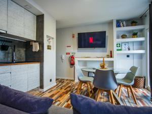 a kitchen and dining room with a table and chairs at Oceanway Apartment in the Center of Baleal in Ferrel