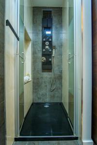 a shower with a glass door in a bathroom at Oceanway Apartment in the Center of Baleal in Ferrel +9 photos