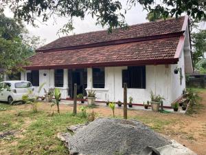 a white house with a red roof at Pap De Home in Weligama