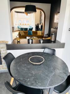 a dining room with a table and chairs at La Villa Delsa in Namur