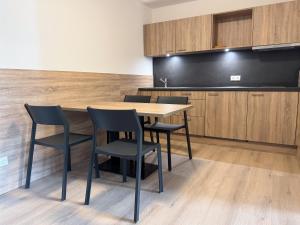 a table and chairs in a kitchen with a blackboard at A2 Hotel Memmingen - SELF-CHECK-IN in Memmingen
