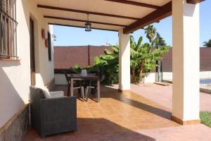 an outdoor patio with a table and chairs at Casa Lucia Conil in Conil de la Frontera +17 photos