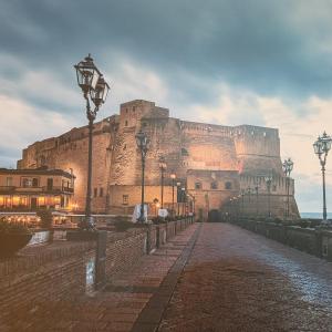 a large castle with a street light in front of it at Nonnacettyhouse in Torre del Greco