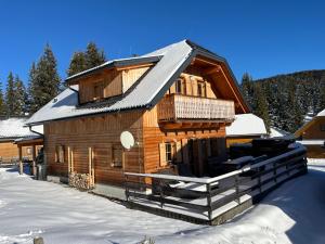 a log cabin in the snow with snow at TANAs Almhütte in Flattnitz