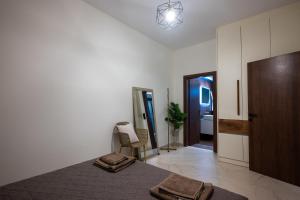 a bedroom with a bed with two towels on it at Olea Blue Suite in Stalís