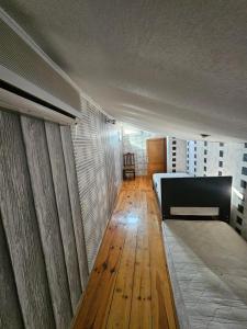 a bedroom with a bed and a wooden floor at Home in Ancient District in Tbilisi City +4 photos