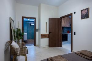 a bedroom with a door leading to a kitchen at Olea Blue Suite in Stalís +29 photos