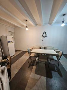 a room with a table and chairs and a refrigerator at Home in Ancient District in Tbilisi City