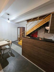 a living room with a table and a staircase at Home in Ancient District in Tbilisi City