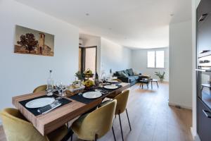 a dining room and living room with a table and chairs at Nebbiu - 25km de Bastia in Murato +5 photos