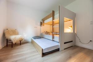 a small room with a bunk bed and a chair at Nebbiu - 25km de Bastia in Murato