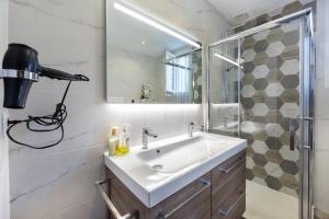 a bathroom with a sink and a shower and a mirror at Nebbiu - 25km de Bastia in Murato