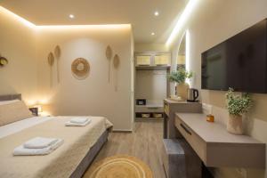 a bedroom with a large bed and a television at Del Mare Rooms in Vlorë