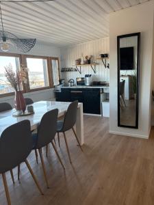 a kitchen and dining room with a table and chairs at Seaview apartment in Mariehamn