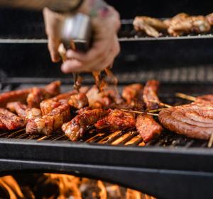 a person is cooking meat on a grill at Hotel Allegade 10 in Copenhagen