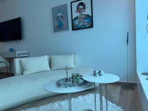 a living room with a couch and two tables at SKYLINE SUITES Tunisia in Tunis