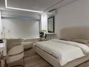 a bedroom with a large bed and a window at SKYLINE SUITES Tunisia in Tunis