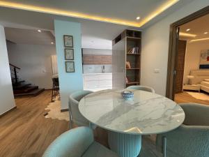 a dining room with a glass table and chairs at SKYLINE SUITES Tunisia in Tunis