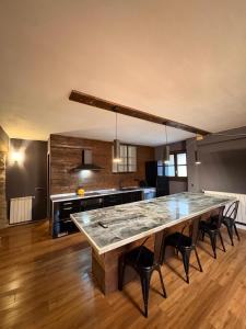 a large kitchen with a large table in a room at Camping Ripolles in Ripoll