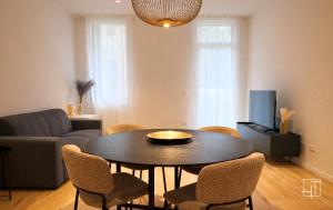 a living room with a table and chairs and a couch at HT - Luxury suite in Piazza del Santo in Padova