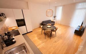 a kitchen and a living room with a table and a couch at HT - Luxury suite in Piazza del Santo in Padova