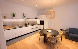 a kitchen and dining room with a table in a room at HT - Luxury suite in Piazza del Santo in Padova