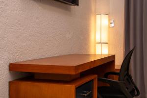 a desk with a chair next to a wall at Tribe Boutique Resort by Mega Stays in Guayacanes