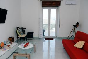 a living room with a red couch and a camera at La terrazza in Contursi