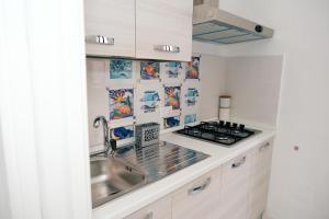 a kitchen with a sink and a stove at La terrazza in Contursi
