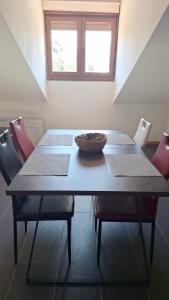 a dining room table with chairs and a bowl on it at Aldea Bricia 20 BC in Posada de Llanes +8 photos